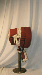 Victorian Burgundy Fabric Bonnet with Ruffled Details & Ivory Lace Bows – Classic 19th-Century Style Headpiece ARHA1009